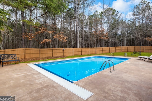 view of swimming pool with a patio, a fenced in pool, and a fenced backyard