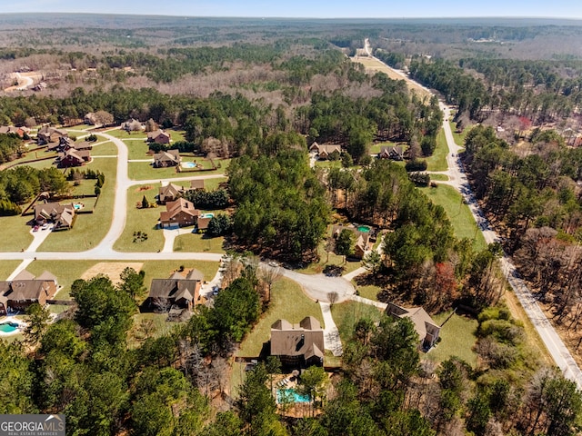 bird's eye view featuring a wooded view