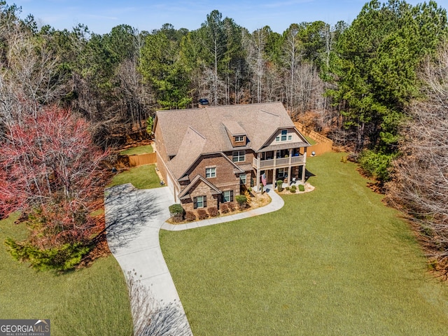 birds eye view of property with a forest view