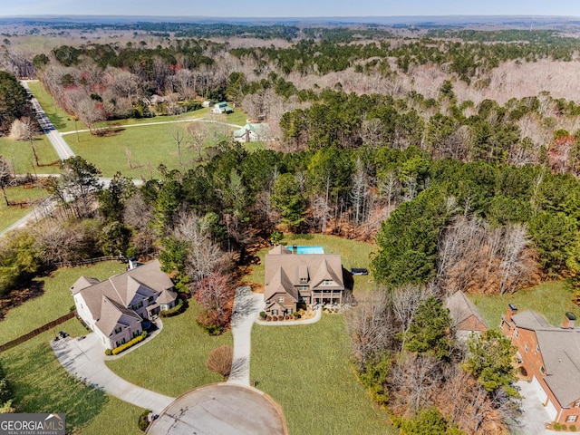 bird's eye view featuring a wooded view