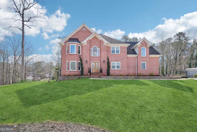 view of front of property with brick siding and a front lawn