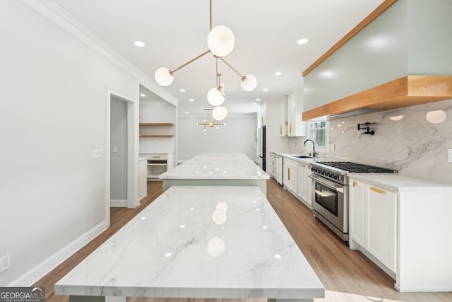 kitchen featuring custom range hood, a sink, tasteful backsplash, a center island, and stainless steel appliances