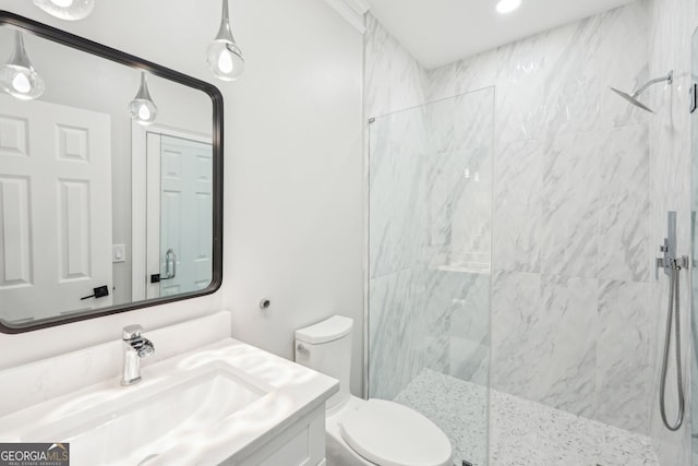 full bathroom with vanity, toilet, and a marble finish shower