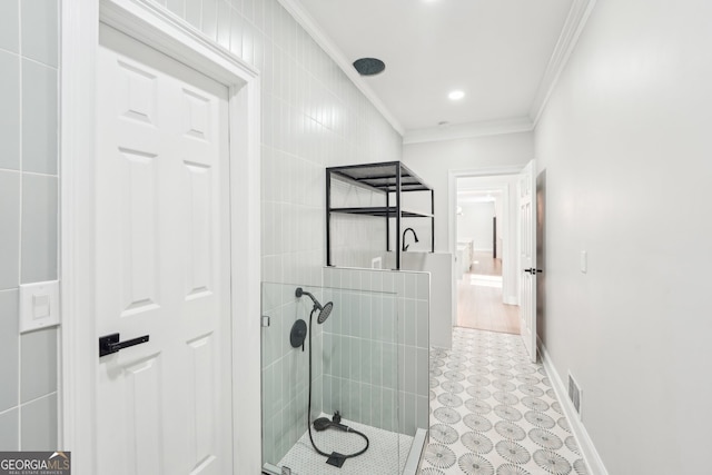 bathroom with crown molding, a walk in shower, visible vents, and baseboards