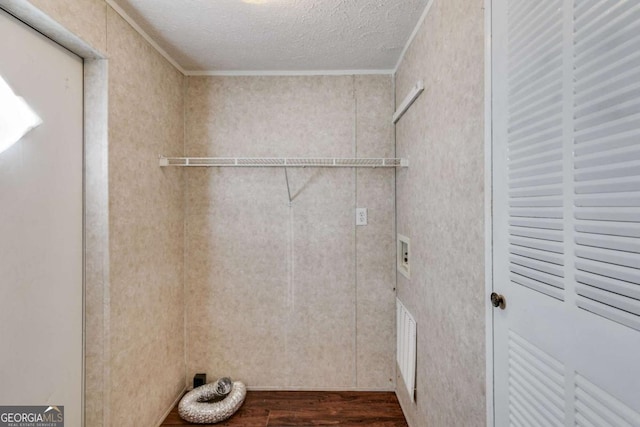 washroom featuring ornamental molding, laundry area, wood finished floors, hookup for an electric dryer, and a textured ceiling