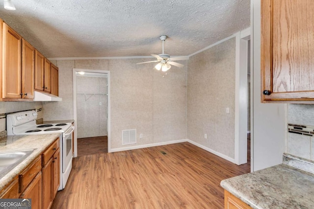 kitchen featuring visible vents, a ceiling fan, under cabinet range hood, white range with electric stovetop, and light wood-style floors