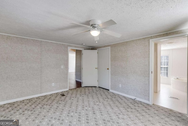 unfurnished bedroom with carpet flooring, a textured ceiling, and ceiling fan