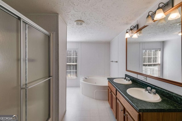 bathroom featuring a sink, a garden tub, a stall shower, and double vanity