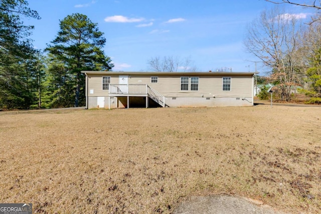 rear view of property with crawl space, stairway, a yard, and a deck