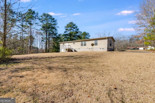 back of house featuring crawl space and a yard