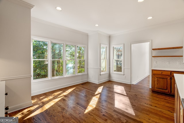 unfurnished dining area featuring recessed lighting, wood finished floors, and ornamental molding