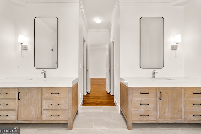 bathroom with a sink, two vanities, and crown molding