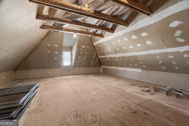 additional living space featuring lofted ceiling