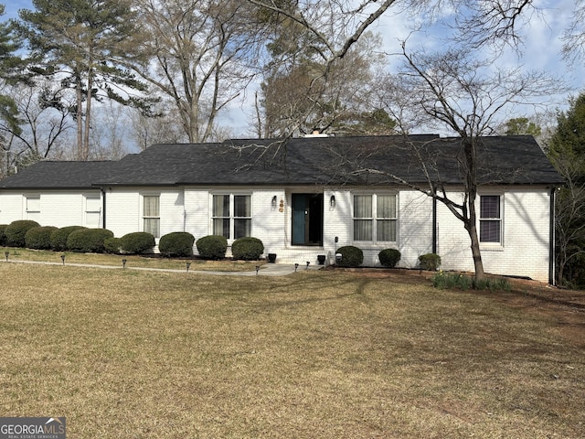 single story home with brick siding, roof with shingles, a front lawn, and entry steps