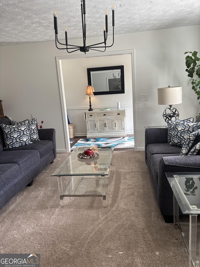 carpeted living room featuring a notable chandelier, baseboards, and a textured ceiling