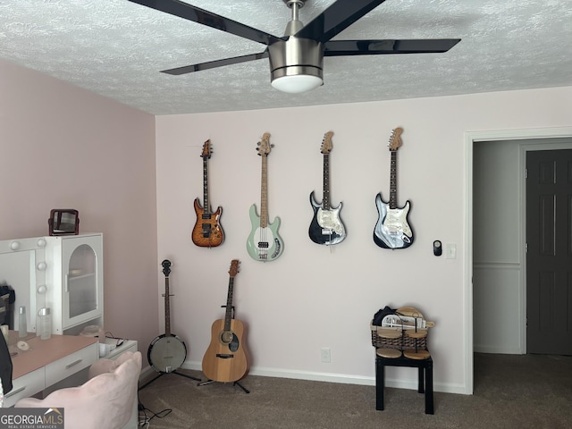 miscellaneous room with a ceiling fan, baseboards, carpet floors, and a textured ceiling