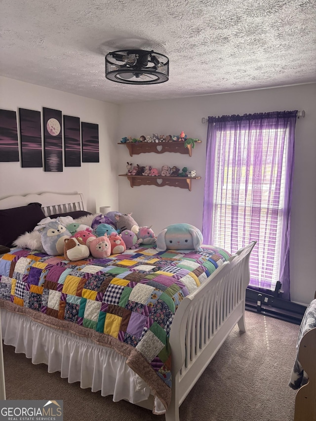 bedroom with carpet and a textured ceiling