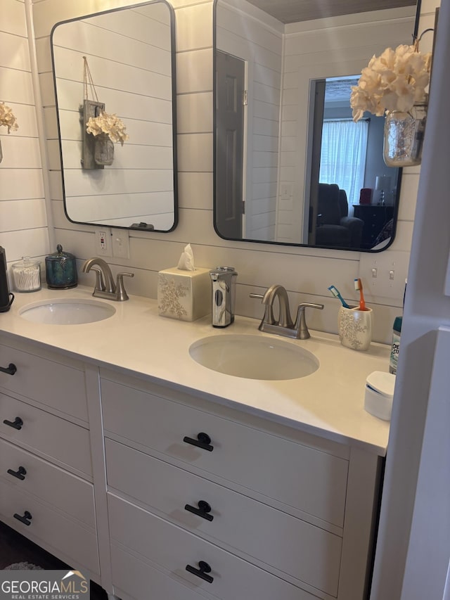 full bathroom featuring a sink and double vanity