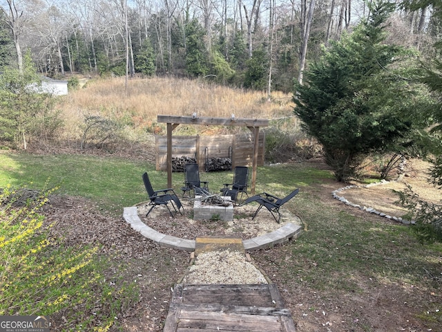 view of yard with a fire pit