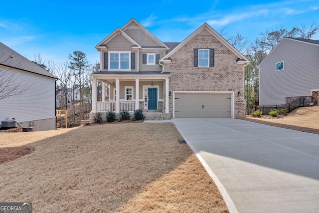 craftsman-style home featuring driveway, central AC, fence, covered porch, and an attached garage