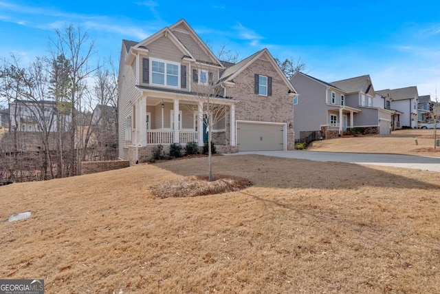 view of front of property featuring driveway, a front lawn, a porch, a residential view, and an attached garage