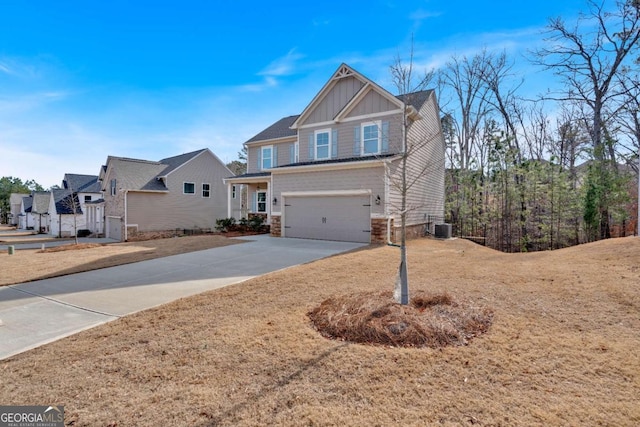 view of front facade with driveway, stone siding, cooling unit, board and batten siding, and a garage