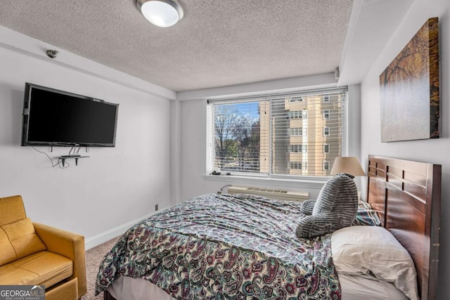 carpeted bedroom featuring a textured ceiling and baseboards