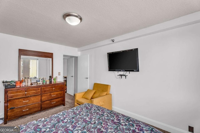 bedroom with carpet, baseboards, and a textured ceiling