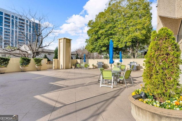 view of patio featuring grilling area and fence