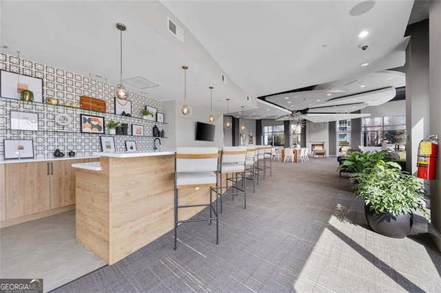 250 Pharr Rd Unit 1702, Atlanta, GA 30305 - kitchen with light brown cabinetry, modern cabinets, plenty of natural light, open floor plan, and recessed lighting