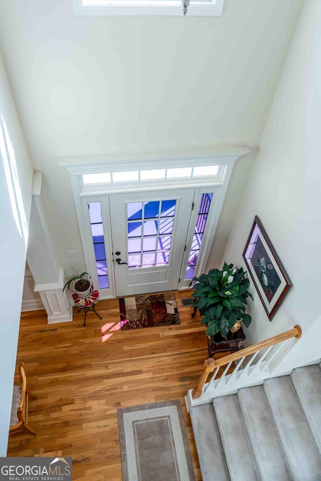 foyer featuring stairs and wood finished floors