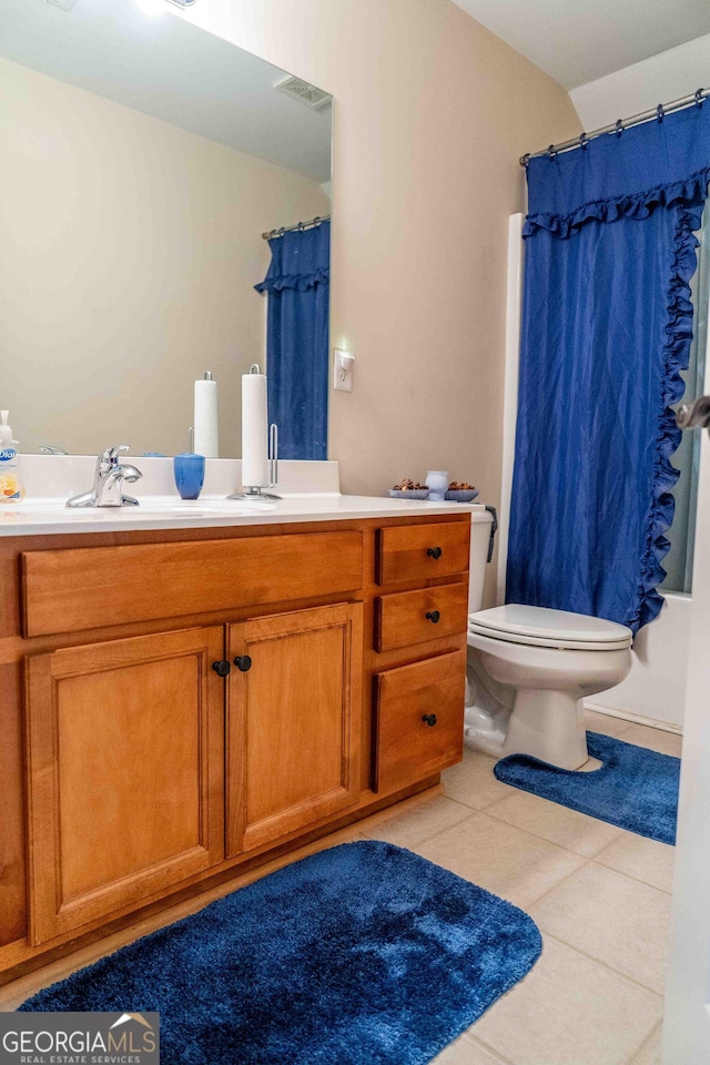 full bathroom with visible vents, toilet, curtained shower, tile patterned flooring, and double vanity