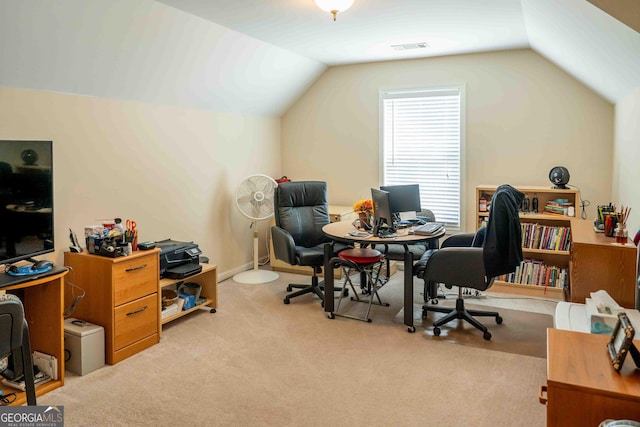 carpeted office with visible vents and lofted ceiling