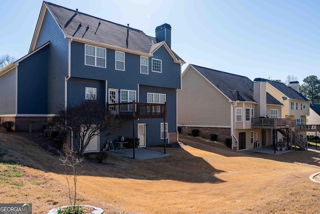 back of property featuring a wooden deck, a patio, a chimney, and stairway