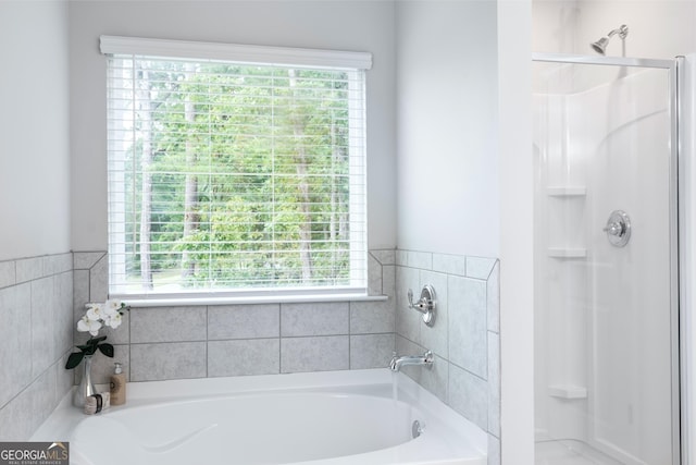 bathroom featuring a garden tub and a stall shower