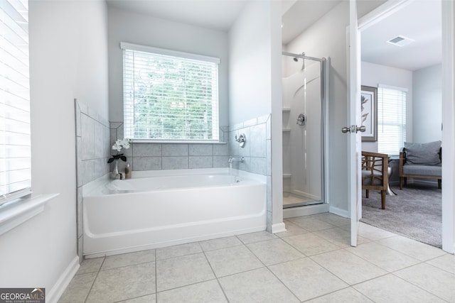 bathroom with tile patterned floors, plenty of natural light, visible vents, and a stall shower