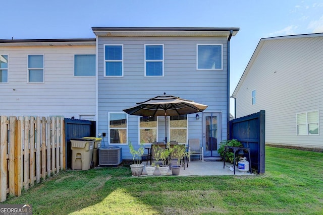 back of house with a patio area, a fenced backyard, central air condition unit, and a yard