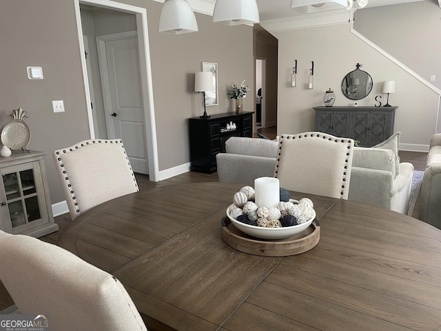 dining room with baseboards, a ceiling fan, wood finished floors, and crown molding