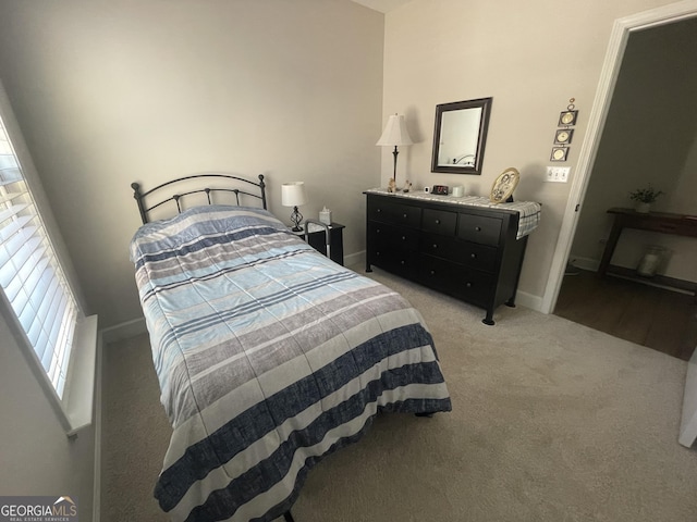 carpeted bedroom featuring baseboards