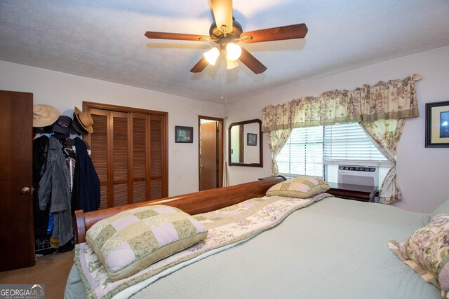 1972 Cox Dr, Austell, GA 30168 - bedroom featuring carpet floors, ceiling fan, a wall mounted air conditioner, and a closet