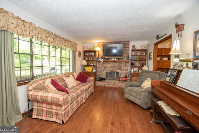 1972 Cox Dr, Austell, GA 30168 - living room featuring a textured ceiling, wood finished floors, and a fireplace