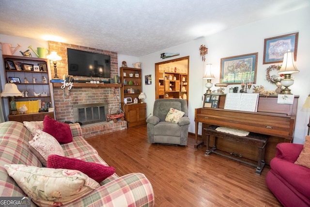 1972 Cox Dr, Austell, GA 30168 - living room featuring a textured ceiling, wood finished floors, and a fireplace
