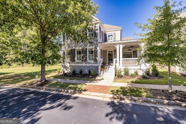 view of front facade featuring a porch, a ceiling fan, and a front lawn