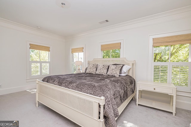 carpeted bedroom featuring visible vents, multiple windows, and ornamental molding