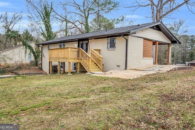 exterior space with brick siding, stairs, a yard, crawl space, and a patio