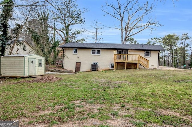 back of property featuring a lawn, stairway, a storage shed, an outdoor structure, and a wooden deck