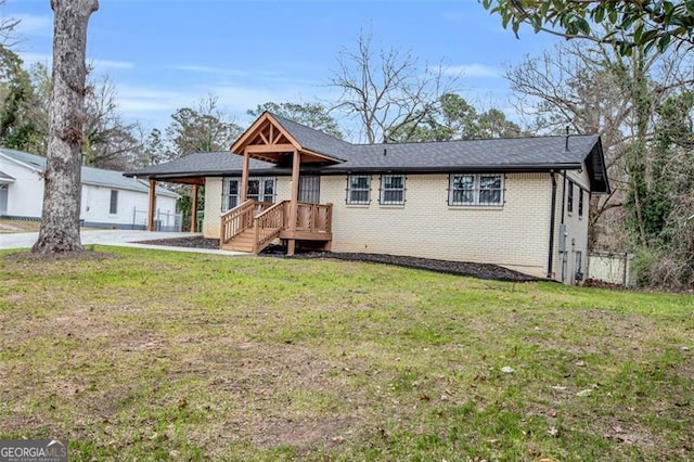 view of front of property with a front lawn and brick siding