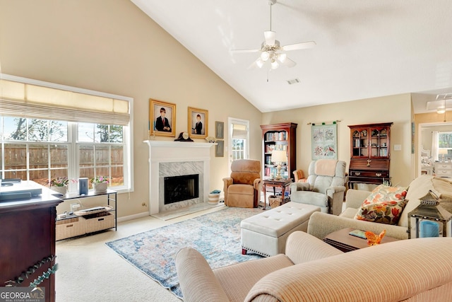 living area with carpet flooring, visible vents, plenty of natural light, and ceiling fan