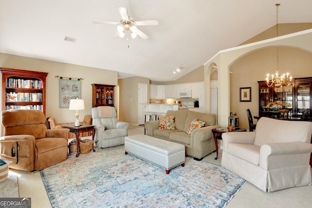 carpeted living area with arched walkways, visible vents, ceiling fan with notable chandelier, and vaulted ceiling