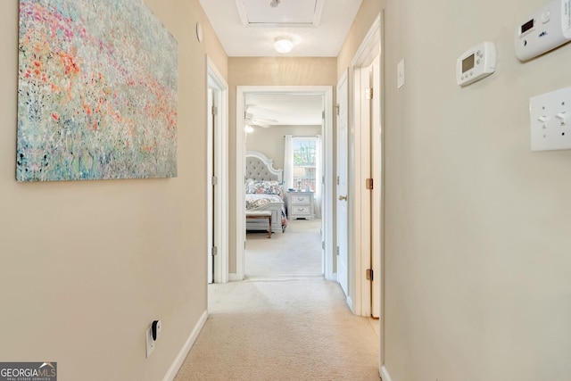 corridor with baseboards and carpet floors